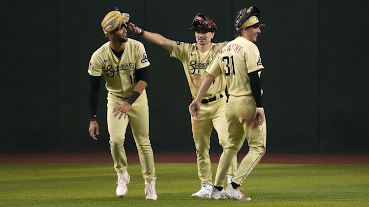 Jun 16, 2023; Phoenix, Arizona, USA; Arizona Diamondbacks left fielder Lourdes Gurriel Jr. (12) and Arizona Diamondbacks center fielder Corbin Carroll (7) and Arizona Diamondbacks right fielder Jake McCarthy (31) celebrate after defeating the Cleveland Guardians at Chase Field. Mandatory Credit: Joe Camporeale-Imagn Images