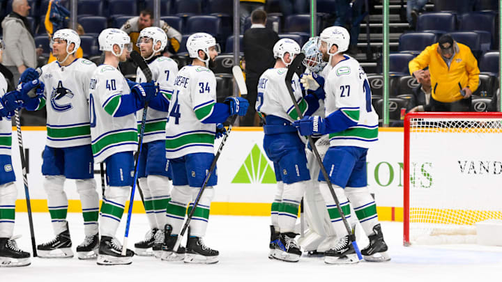 Jan 29, 2025; Nashville, Tennessee, USA;  Vancouver Canucks goaltender Thatcher Demko (35) celebrates the win with his teammates against the Nashville Predators during the third period at Bridgestone Arena. Mandatory Credit: Steve Roberts-Imagn Images