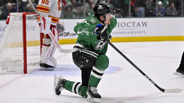 Mar 6, 2025; Dallas, Texas, USA; Dallas Stars center Roope Hintz (24) gets up from the ice after being checked by the Calgary Flames during the second period at the American Airlines Center. Mandatory Credit: Jerome Miron-Imagn Images