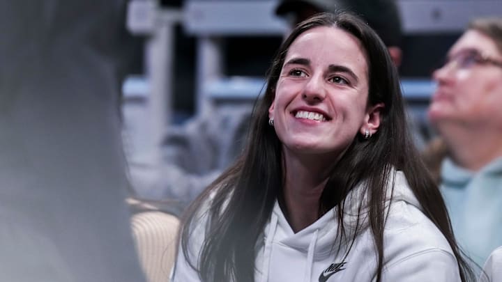 Indiana Fever guard Caitlin Clark (22) smiles Thursday, March 6, 2025, in a round two game at the 2025 TIAA Big Ten Women's Basketball Tournament between the Iowa Hawkeyes and the Michigan State Spartans at Gainbridge Fieldhouse in Indianapolis.