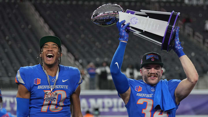 Boise State quarterback Taylen Green (10) and safety Alexander Teubner celebrate after winning the 2023 Mountain West title. 