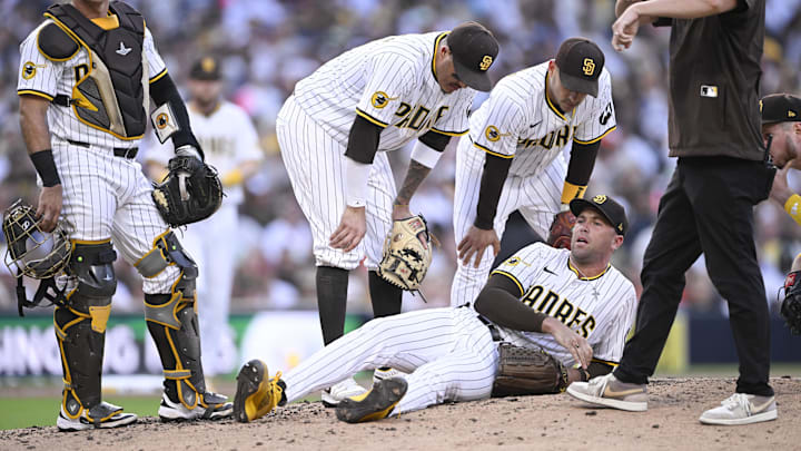 Sep 1, 2025; San Diego, California, USA; San Diego Padres relief pitcher Jason Adam (40) lies on the ground during the seventh inning against the Baltimore Orioles at Petco Park. Adam was taken away in a cart after the play. Mandatory Credit: Denis Poroy-Imagn Images