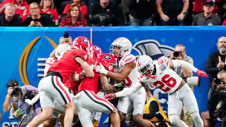 Dec 31, 2022; Atlanta, Georgia, USA; Georgia Bulldogs running back Kendall Milton (2) scores a rushing touchdown against Ohio State Buckeyes safety Sonny Styles (20) during the second quarter of the Peach Bowl in the College Football Playoff semifinal at Mercedes-Benz Stadium.
