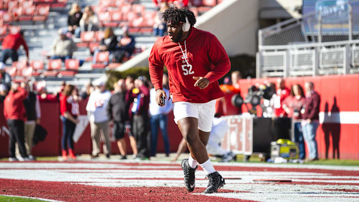 Nov 30, 2024; Tuscaloosa, Alabama, USA; Alabama Crimson Tide offensive lineman Tyler Booker (52) warms up before a game against the Auburn Tigers at Bryant-Denny Stadium. Mandatory Credit: Will McLelland-Imagn Images
