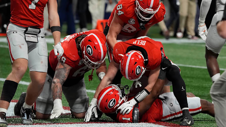 Georgia running back Trevor Etienne (1) celebrates with his teammates after scoring the game winning touchdown Saturday during overtime of the SEC championship game against Texas. Georgia won 22-19.