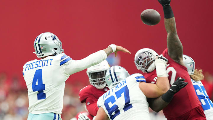 Dallas Cowboys quarterback Dak Prescott throws over the reach of Arizona Cardinals defensive end Kevin Strong Dallas Cowboys quarterback Dak Prescott throws over the reach of Arizona Cardinals defensive end Kevin Strong