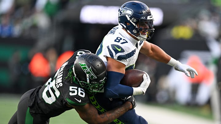 Dec 1, 2024; East Rutherford, New Jersey, USA; Seattle Seahawks tight end Noah Fant (87) runs with the ball during the third quarter and is tackled by New York Jets linebacker Quincy Williams (56) at MetLife Stadium. Mandatory Credit: Mark Smith-Imagn Images
