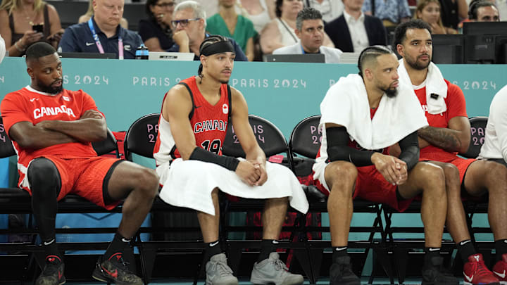 Aug 6, 2024; Paris, France; Canada point guard Andrew Nembhard (19) and small forward Dillon Brooks (24) look on from the bench in the fourth quarter against France in a men’s basketball quarterfinal game during the Paris 2024 Olympic Summer Games at Accor Arena. Mandatory Credit: Kyle Terada-Imagn Images Aug 6, 2024; Paris, France; Canada point guard Andrew Nembhard (19) and small forward Dillon Brooks (24) look on from the bench in the fourth quarter against France in a men’s basketball quarterfinal game during the Paris 2024 Olympic Summer Games at Accor Arena. Mandatory Credit: Kyle Terada-Imagn Images