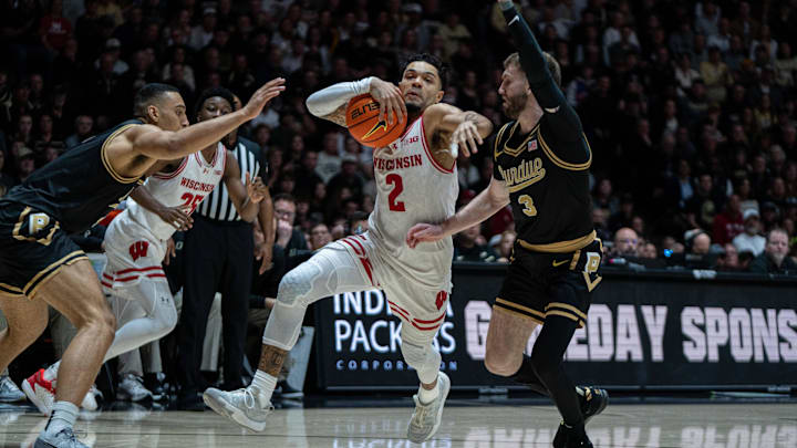 Mar 7, 2026; West Lafayette, Indiana, USA; Wisconsin Badgers guard Nick Boyd (2) drives to the basket as Purdue Boilermakers guard Braden Smith (3) defends during the first half at Mackey Arena.
