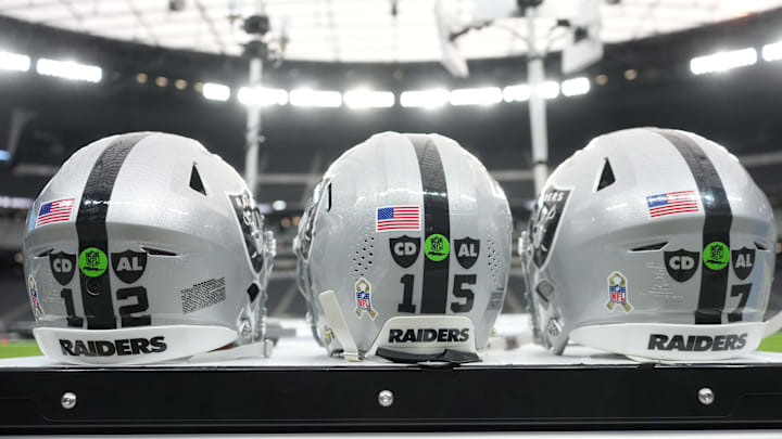Nov 23, 2025; Paradise, Nevada, USA; The Las Vegas Raiders helmets of Las Vegas Raiders quarterback Aidan O'Connell (12), quarterback Kenny Pickett (15) and quarterback Geno Smith (7) with the Salute to Service decals and emblems honoring Al Davis and Carol Davis at Allegiant Stadium. Mandatory Credit: Kirby Lee-Imagn Images Nov 23, 2025; Paradise, Nevada, USA; The Las Vegas Raiders helmets of Las Vegas Raiders quarterback Aidan O'Connell (12), quarterback Kenny Pickett (15) and quarterback Geno Smith (7) with the Salute to Service decals and emblems honoring Al Davis and Carol Davis at Allegiant Stadium. Mandatory Credit: Kirby Lee-Imagn Images