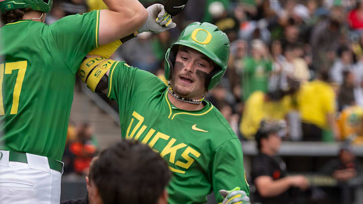 Oregon outfielder Mason Neville, right, celebrates a home run with teammate Drew Smith as the Oregon Ducks host the Oregon State Beavers on April 25, 2025, at PK Park in Eugene.