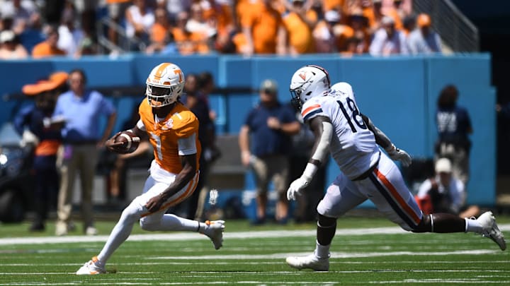 Tennessee Volunteers quarterback Joe Milton III (7) eludes Virginia Cavaliers defensive tackle Michael Diatta (18) during their game at Nissan Stadium Saturday, Sept. 2, 2023.