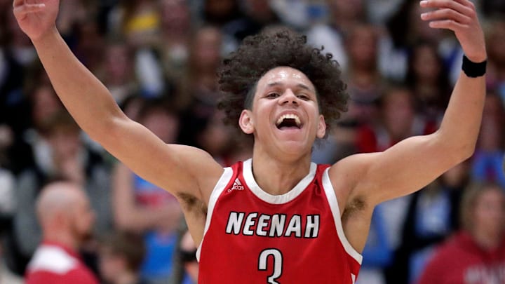 Neenah High School's Chevalier Emery Jr. celebrates after making a three-pointer at the buzzer to defeat Kimberly High School. 