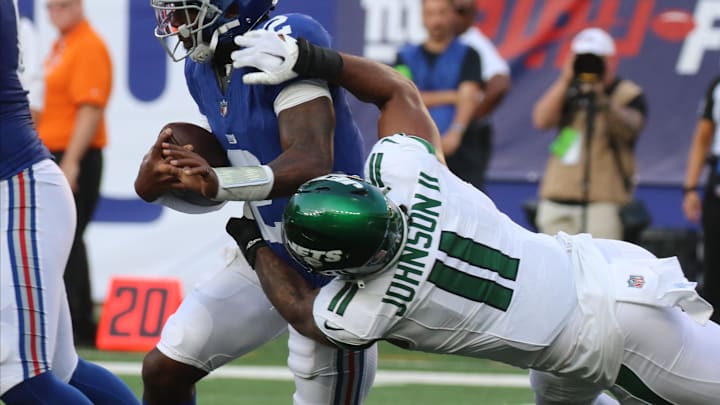 East Rutherford, NJ August 26, 2023 -- Jermaine Johnson II of the Jets tackles NY Giants quarterback Tyrod Taylor in the first half. New The NY Jets against the NY Giants on August 26, 2023 at MetLife Stadium in East Rutherford, NJ, as the rivals play their final preseason game before the start of the NFL season. East Rutherford, NJ August 26, 2023 -- Jermaine Johnson II of the Jets tackles NY Giants quarterback Tyrod Taylor in the first half. New The NY Jets against the NY Giants on August 26, 2023 at MetLife Stadium in East Rutherford, NJ, as the rivals play their final preseason game before the start of the NFL season.