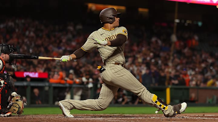 Sep 25, 2023; San Francisco, California, USA; San Diego Padres left fielder Juan Soto (22) hits a single during the ninth inning against the San Francisco Giants at Oracle Park. Mandatory Credit: Sergio Estrada-Imagn Images
