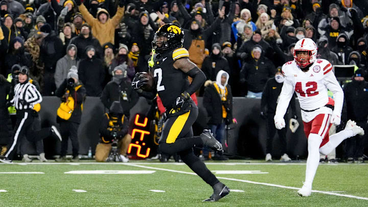 Iowa Hawkeyes running back Kaleb Johnson (2) runs to the endzone to score a touchdown as DUPLICATE***Nebraska Cornhuskers linebacker Mikai Gbayor (42) trails Friday, Nov. 29, 2024 at Kinnick Stadium in Iowa City, Iowa.