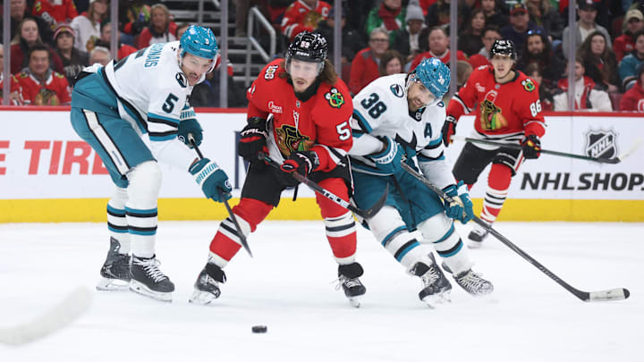 Feb 2, 2026; Chicago, Illinois, USA; Chicago Blackhawks left wing Tyler Bertuzzi (59), San Jose Sharks defenseman Vincent Desharnais (5) and defenseman Mario Ferraro (38) battle for control of the puck during the first period at United Center. Mandatory Credit: Talia Sprague-Imagn Images Feb 2, 2026; Chicago, Illinois, USA; Chicago Blackhawks left wing Tyler Bertuzzi (59), San Jose Sharks defenseman Vincent Desharnais (5) and defenseman Mario Ferraro (38) battle for control of the puck during the first period at United Center. Mandatory Credit: Talia Sprague-Imagn Images