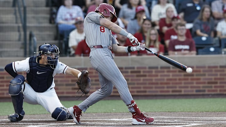 Jun 1, 2024; Norman, OK, USA; Oklahoma Sooners outfielder John Spikerman (8) hits during the first inning of an NCAA Division I Baseball Championship game between the UConn Huskies and the Oklahoma Sooners at L. Dale Mitchell Park. Credit: Alonzo Adams-Imagn Images