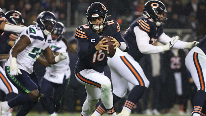 Caleb Williams rolls out of the pocket on a bootleg pass against Seattle last season.