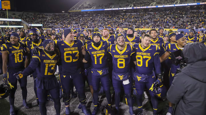 Nov 23, 2024; Morgantown, West Virginia, USA; West Virginia Mountaineers players celebrate after defeating the UCF Knights at Mountaineer Field at Milan Puskar Stadium. Mandatory Credit: Ben Queen-Imagn Images