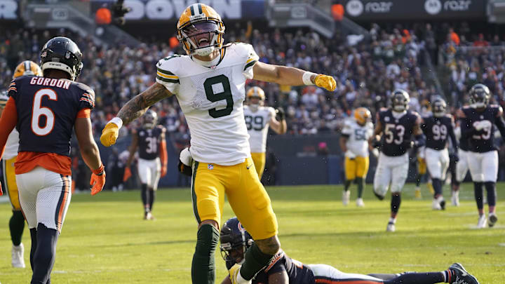 Christian Watson celebrates a catch against the Bears at Soldier Field. 