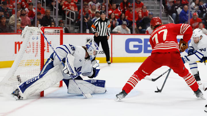 Dec 28, 2025; Detroit, Michigan, USA;  Detroit Red Wings defenseman Simon Edvinsson (77) scores on Toronto Maple Leafs goaltender Dennis Hildeby (35) in overtime at Little Caesars Arena. Mandatory Credit: Rick Osentoski-Imagn Images