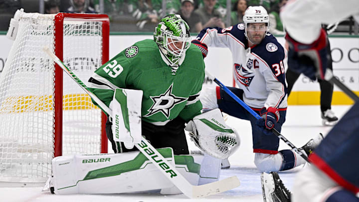 Oct 21, 2025; Dallas, Texas, USA; Columbus Blue Jackets center Boone Jenner (38) scores a power play goal against Dallas Stars goaltender Jake Oettinger (29) during the first period at the American Airlines Center. Mandatory Credit: Jerome Miron-Imagn Images
