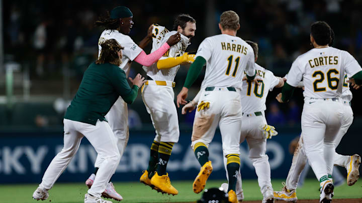 Sep 26, 2025; West Sacramento, California, USA; Athletics catcher Shea Langeliers (23) celebrates with teammates after hitting a walk-off RBI double during the ninth inning against the Kansas City Royals at Sutter Health Park. Mandatory Credit: Sergio Estrada-Imagn Images Sep 26, 2025; West Sacramento, California, USA; Athletics catcher Shea Langeliers (23) celebrates with teammates after hitting a walk-off RBI double during the ninth inning against the Kansas City Royals at Sutter Health Park. Mandatory Credit: Sergio Estrada-Imagn Images
