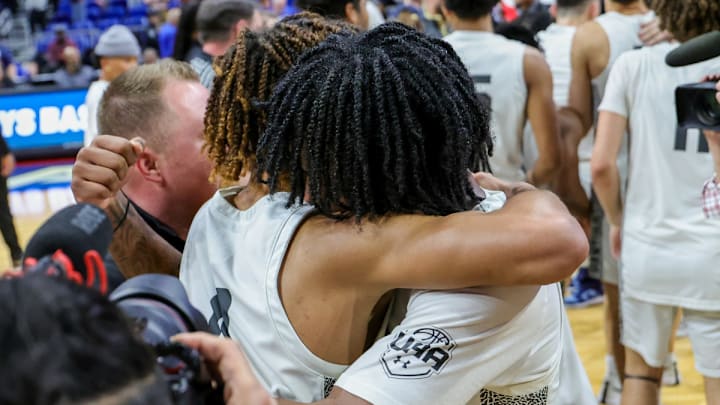 Plano East players embrace in the celebratory moments after clinching a UIL 6A state title, perfect 40-0 season on Saturday at the Alamodome in San Antonio.