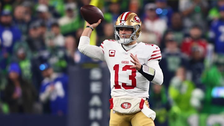 Jan 17, 2026; Seattle, WA, USA; San Francisco 49ers quarterback Brock Purdy (13) throws downfield against the Seattle Seahawks during the first half in an NFC Divisional Round game at Lumen Field.