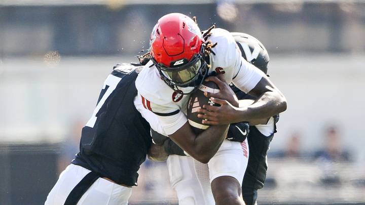 Sep 19, 2026; Nashville, Tennessee, USA; NC State Wolfpack quarterback CJ Bailey (11) gets tackled by Vanderbilt Commodores safety Ricardo Jones (7) and safety Jailen Ruth (14) during the second half at FirstBank Stadium. Mandatory Credit: Steve Roberts-Imagn Images Sep 19, 2026; Nashville, Tennessee, USA; NC State Wolfpack quarterback CJ Bailey (11) gets tackled by Vanderbilt Commodores safety Ricardo Jones (7) and safety Jailen Ruth (14) during the second half at FirstBank Stadium. Mandatory Credit: Steve Roberts-Imagn Images