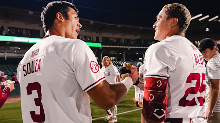 Nolan Souza and Kuhio Aloy celebrate Aloy's double that drove in Souza to run-rule No. 17 Ole Miss, 12-2, at Baum-Walker Stadium.
