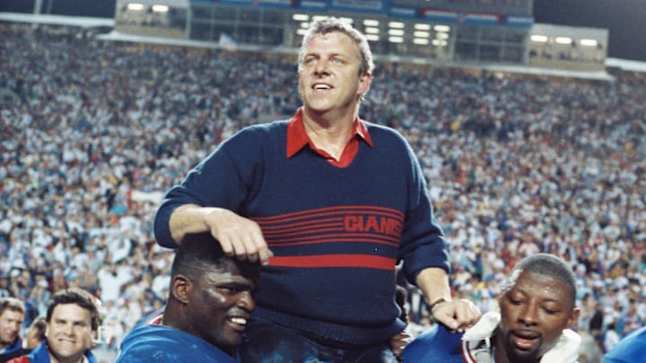 New York Giants Lawrence Taylor and Carl Banks carry head coach Bill Parcells off the field after the Giants defeated the Buffalo Bills 20-19 in Super Bowl XXV at Tampa Stadium in Tampa Florida Jan. 27, 1991.