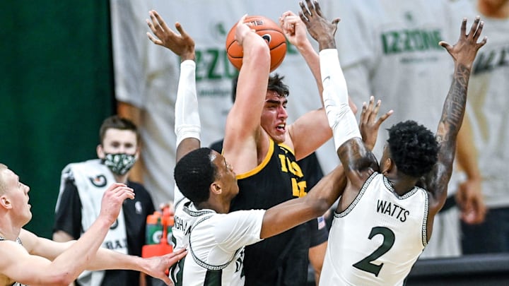 From left, Michigan State's Joey Hauser, Marcus Bingham Jr. and Rocket Watts pressure Iowa's Luka Garza during the first half on Saturday, Feb. 13, 2021, at the Breslin Center in East Lansing.

210213 Msu Iowa 096a
