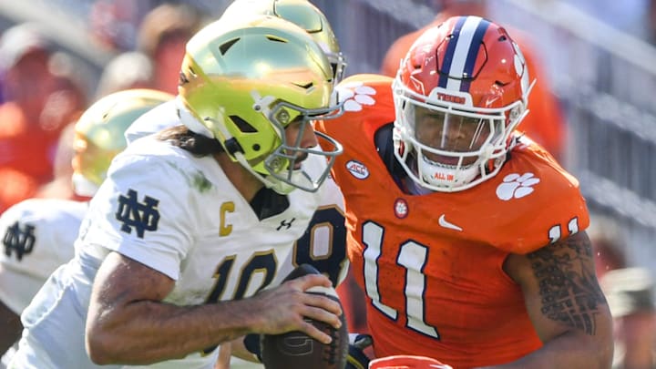Notre Dame quarterback Sam Hartman (10) runs by Clemson defensive lineman Peter Woods (11) for a touchdown during the third quarter at Memorial Stadium in Clemson, S.C. Saturday, November 4, 2023.