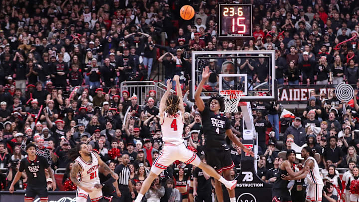 Houston's Kingston Flemings kicks his leg out on a 3-point attempt against Texas Tech's Christian Anderson during a Big 12 Conference men's basketball game, Saturday, Jan. 24, 2026, in United Supermarkets Arena. Flemings was called for an offensive foul.