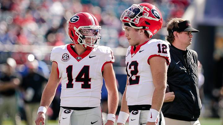 Nov 1, 2025; Jacksonville, Florida, USA; Georgia Bulldogs quarterback Gunner Stockton (14) talks with quarterback Ryan Puglisi (12) before a college football game against the Florida Gators at EverBank Stadium. Mandatory Credit: Travis Register-Imagn Images