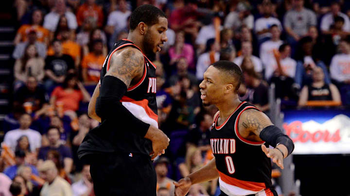 Mar 27, 2015; Phoenix, AZ, USA; Portland Trail Blazers forward LaMarcus Aldridge (12) celebrates with guard Damian Lillard (0) after making a basket against the Phoenix Suns during the second half at US Airways Center. The Trail Blazers won the game 87-81. Mandatory Credit: Joe Camporeale-Imagn Images