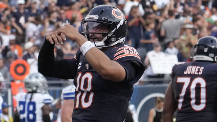 Sep 21, 2025; Chicago, Illinois, USA; Chicago Bears quarterback Caleb Williams (18) gestures after throwing a touchdown  against the Dallas Cowboys during the second half at Soldier Field. Mandatory Credit: David Banks-Imagn Images