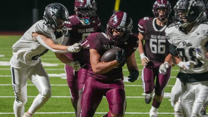 Senior Anthony Solano runs the ball for Woonsocket football in a game against Pilgrim on Sept. 12.
