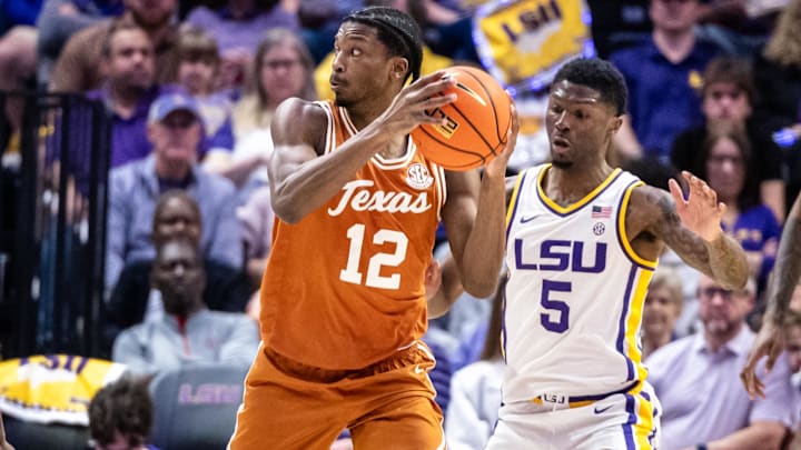 Feb 1, 2025; Baton Rouge, Louisiana, USA; Texas Longhorns guard Tramon Mark (12) looks to pass against LSU Tigers guard Cam Carter (5) during the first half at Pete Maravich Assembly Center. Mandatory Credit: Stephen Lew-Imagn Images