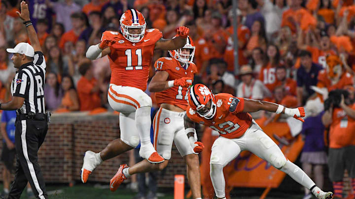 Clemson defensive lineman T.J. Parker (12) reacts with defensive lineman Peter Woods (11) after sacking Florida Atlantic quarterback Daniel Richardson (10) during the second quarter.
