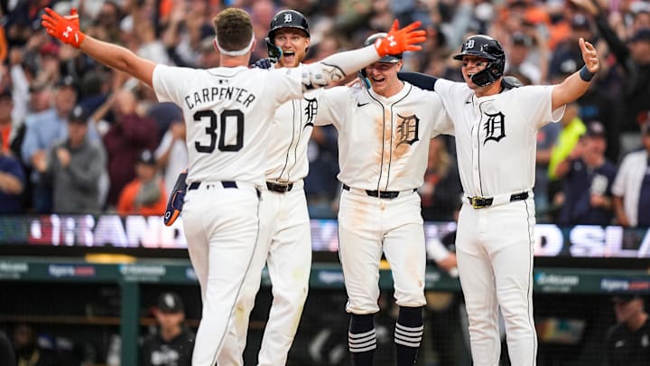 Detroit Tigers designated hitter Kerry Carpenter (30), left, celebrates with teammates center fielder Parker Meadows (22), shortstop Trey Sweeney (27) and first base Spencer Torkelson (20) after batting a grand slam against Chicago White Sox during the fifth inning at Comerica Park in Detroit on Sunday, Sept. 29, 2024 Detroit Tigers designated hitter Kerry Carpenter (30), left, celebrates with teammates center fielder Parker Meadows (22), shortstop Trey Sweeney (27) and first base Spencer Torkelson (20) after batting a grand slam against Chicago White Sox during the fifth inning at Comerica Park in Detroit on Sunday, Sept. 29, 2024