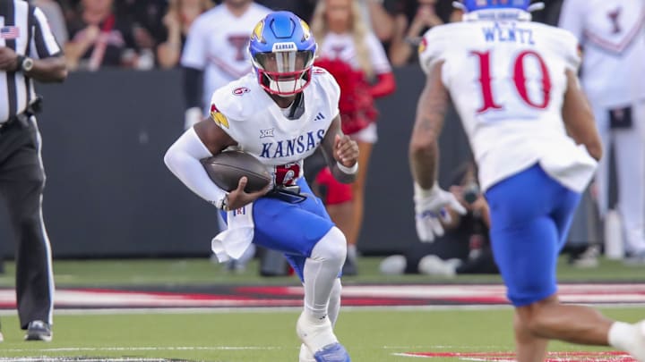 Oct 11, 2025; Lubbock, Texas, USA;  Kansas Jayhawks quarterback Jalon Daniels (6) scrambles against the Texas Tech Red Raiders in the first half at Jones AT&T Stadium. Mandatory Credit: Michael C. Johnson-Imagn Images