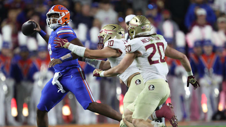 Florida quarterback DJ Lagway (2) gets pressure from Florida State defensive lineman James Williams (10) during the first half of an NCAA football game at Steve Spurrier Field at Ben Hill Griffin Stadium in Gainesville, FL on Saturday, November 29, 2025. [Alan Youngblood/Gainesville Sun]