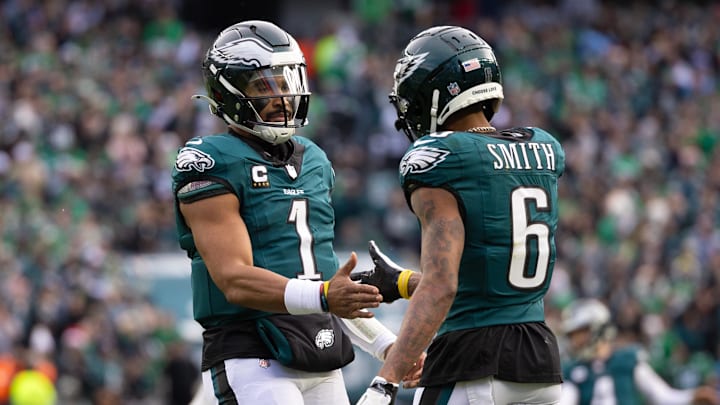 Dec 8, 2024; Philadelphia, Pennsylvania, USA;  Philadelphia Eagles wide receiver DeVonta Smith (6) and quarterback Jalen Hurts (1) celebrate their touchdown connection against the Carolina Panthers during the second quarter at Lincoln Financial Field. Mandatory Credit: Bill Streicher-Imagn Images