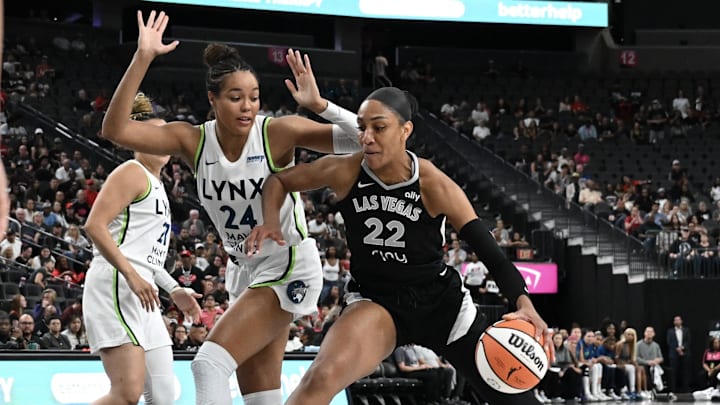 Sep 4, 2025; Las Vegas, Nevada, USA; Las Vegas Aces center A'ja Wilson (22) drives against Minnesota Lynx forward Napheesa Collier (24) in the first quarter of their game at T-Mobile Arena. Mandatory Credit: Candice Ward-Imagn Images