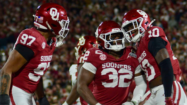 Oklahoma defensive linemen Marvin Jones Jr. and R Mason Thomas and linebacker Kip Lewis celebrate after a sack against Alabama in the CFP.