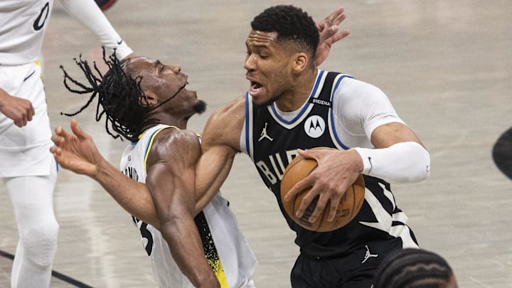 Apr 19, 2025; Indianapolis, Indiana, USA;  Milwaukee Bucks forward Giannis Antetokounmpo (34) dribbles the ball while Indiana Pacers forward Aaron Nesmith (23) defends in the first half at Gainbridge Fieldhouse. Mandatory Credit: Trevor Ruszkowski-Imagn Images