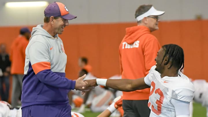 Clemson head coach Dabo Swinney greets cornerback Ashton Hampton (23) during the football practice at the Allen N. Reeves Football Complex at Clemson University in Clemson, S.C. Monday, March 3, 2025.